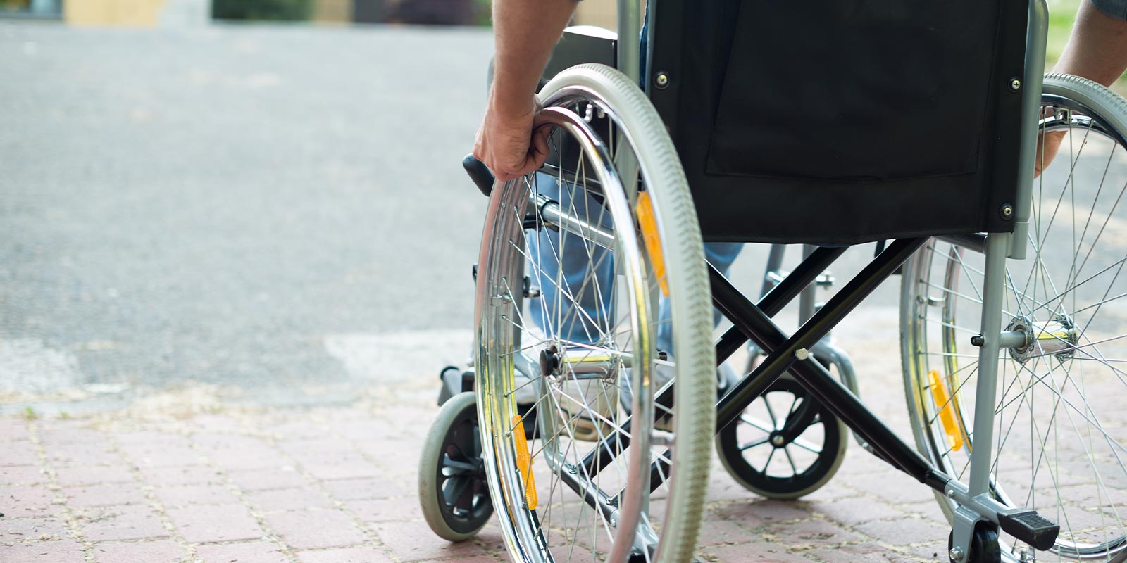 Image of back of wheelchair on street